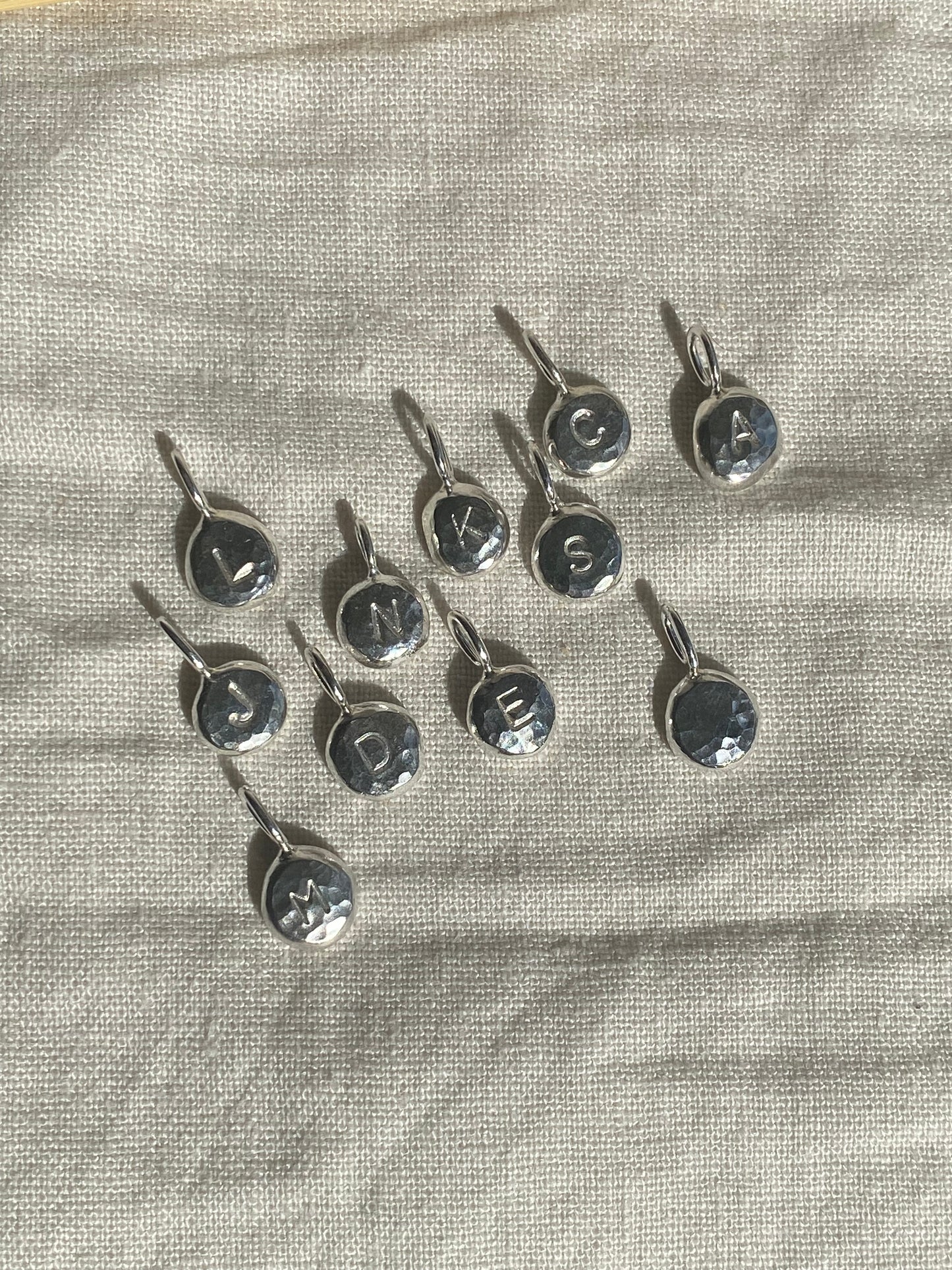 Handmade initial stamped necklace made from recycled sterling silver with hand stamped personalisation