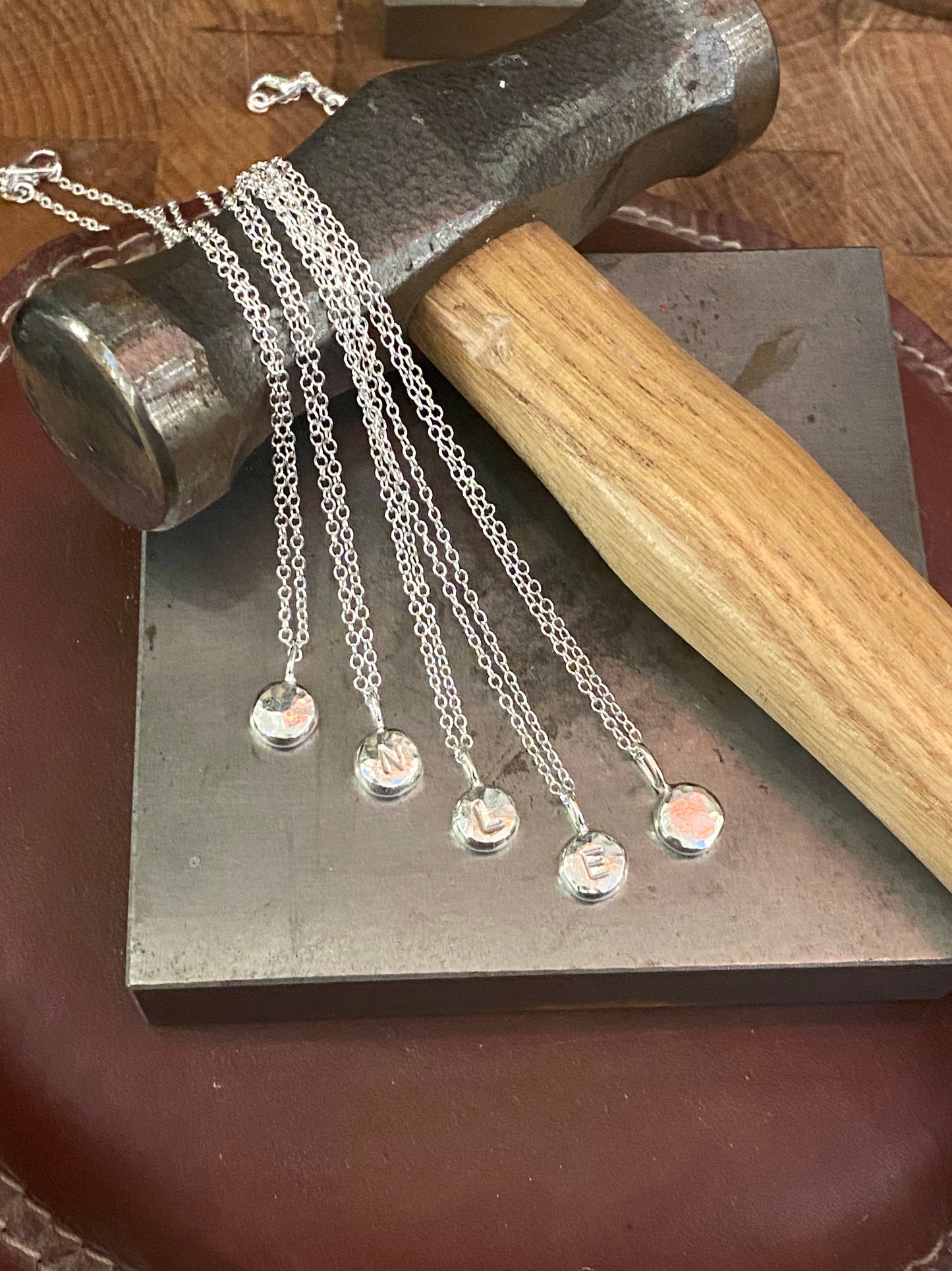 Handmade initial stamped necklace made from recycled sterling silver with hand stamped personalisation