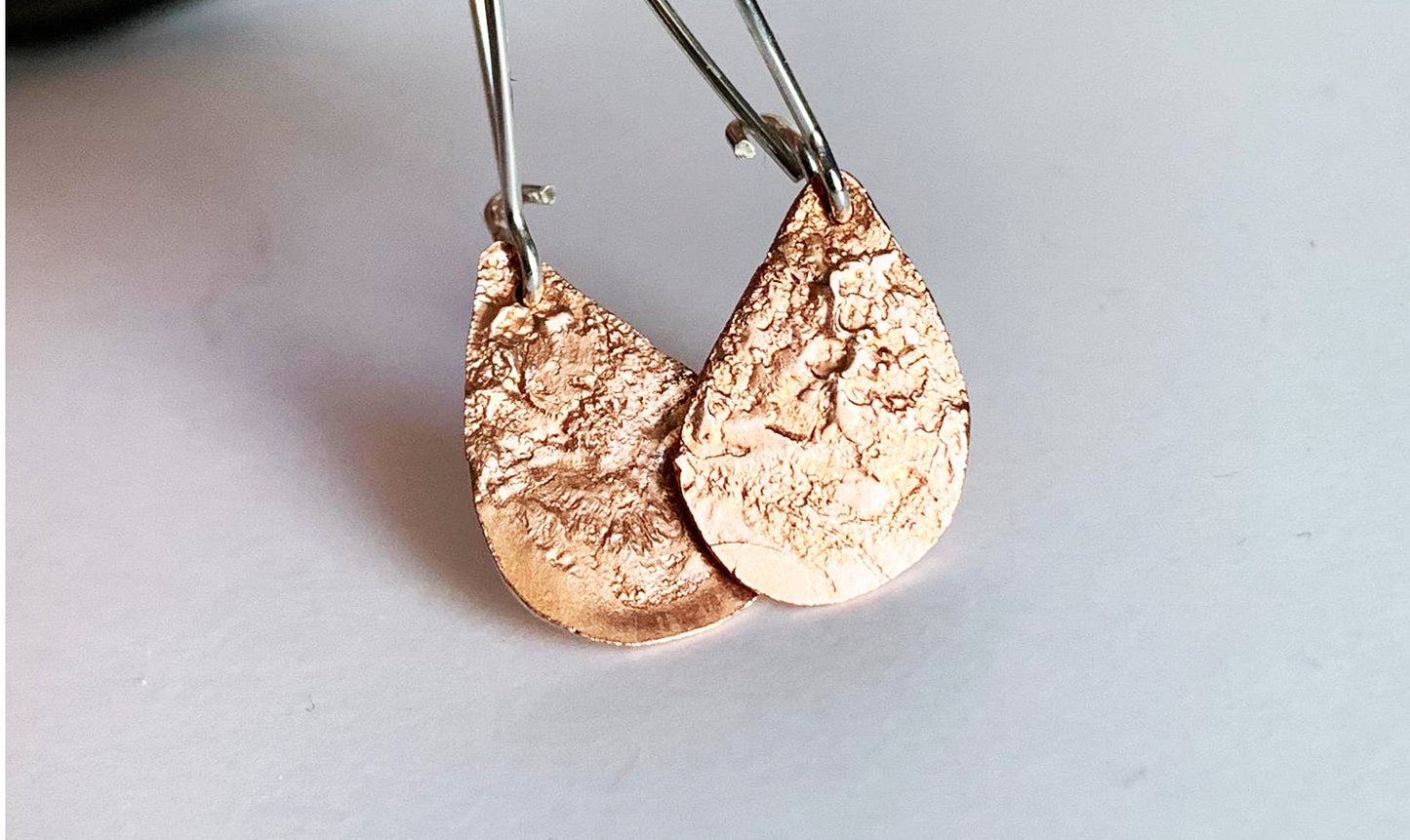 Silver earrings with reticulated copper drops