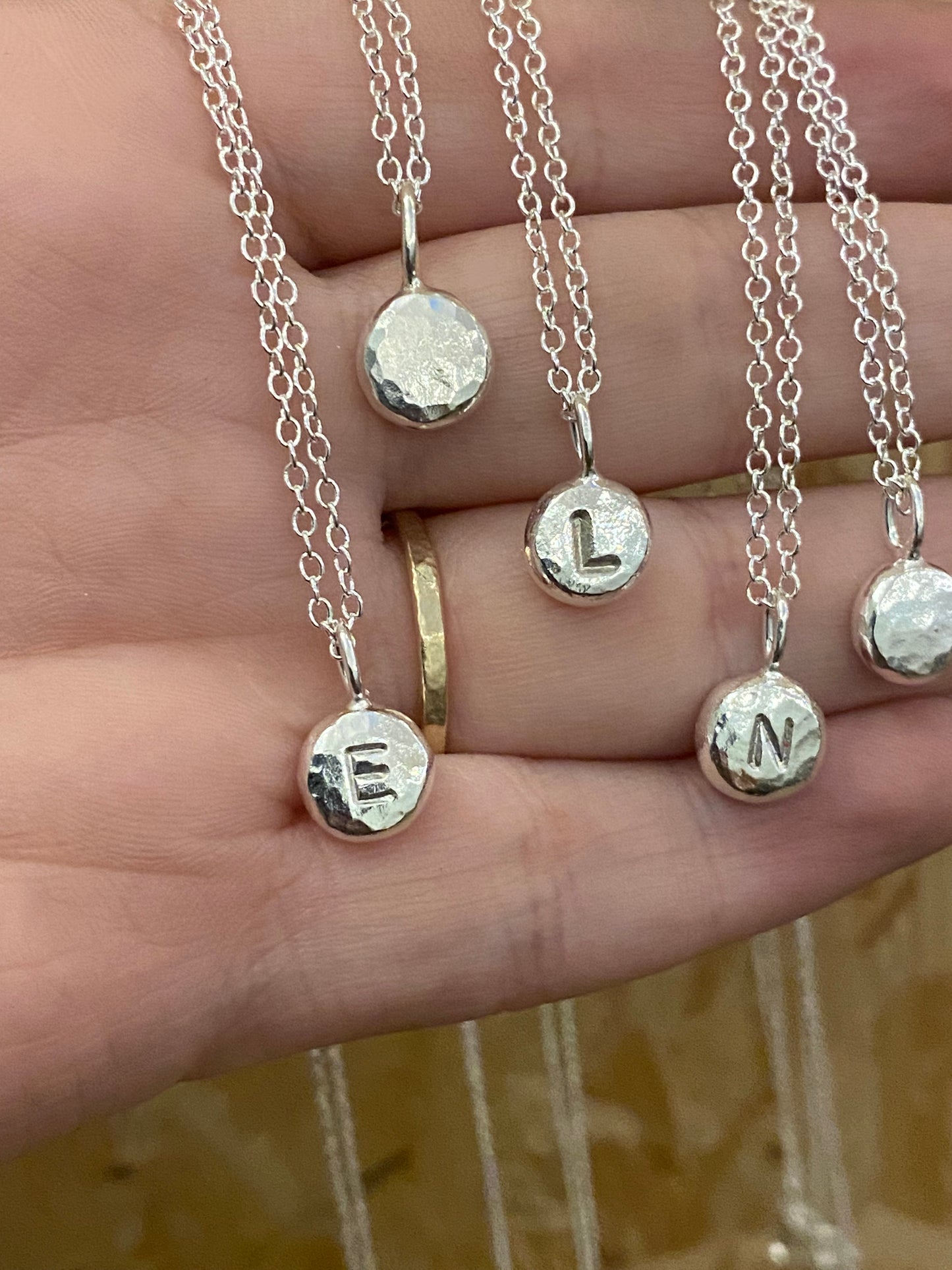 Handmade initial stamped necklace made from recycled sterling silver with hand stamped personalisation
