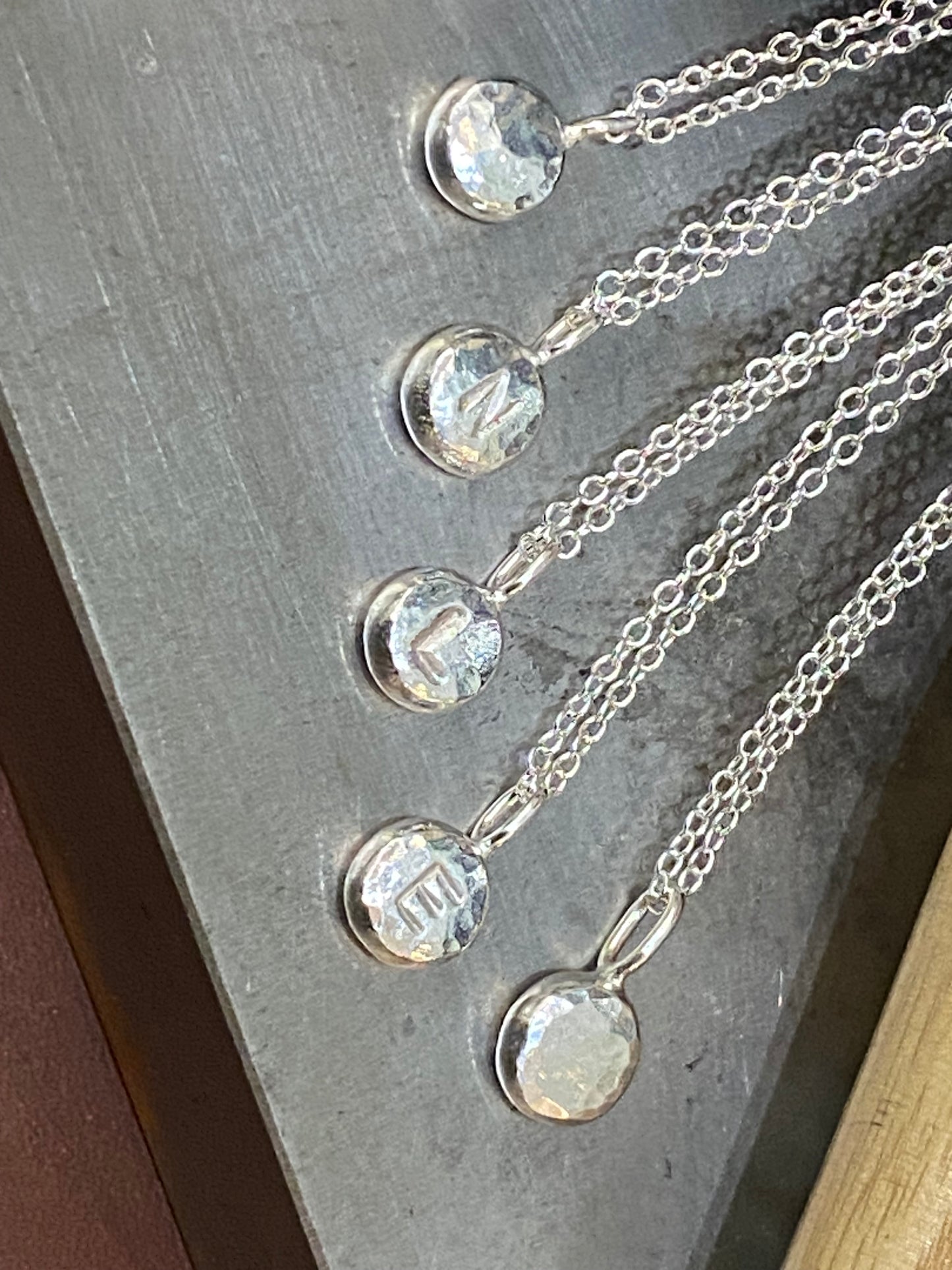 Handmade initial stamped necklace made from recycled sterling silver with hand stamped personalisation