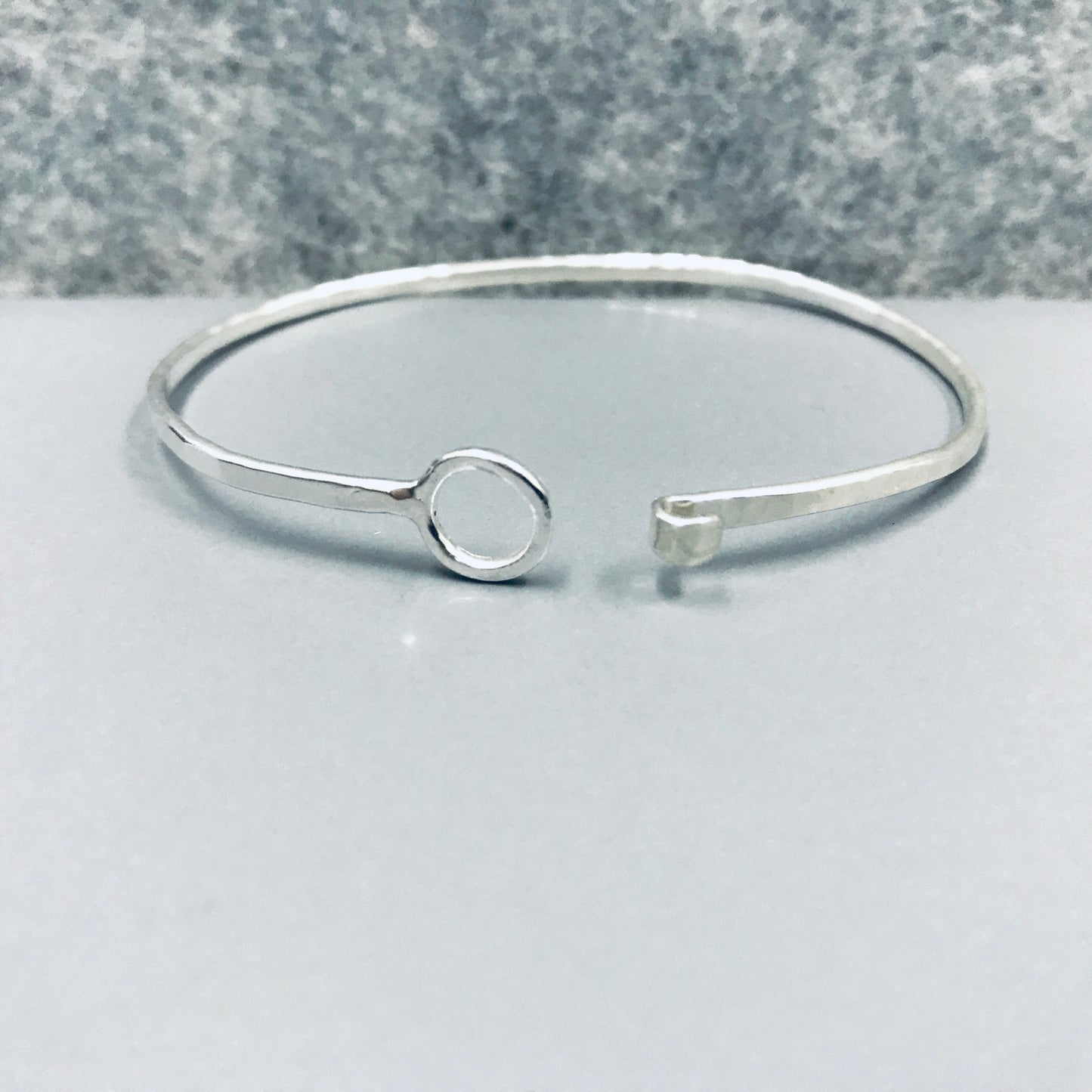 Sterling silver Oval shaped bangle with O clasp